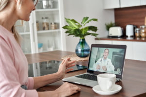Doctor consulting woman virtually