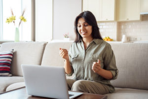 Young female looking at laptop on couch