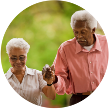 Elderly couple holding hands as they support each other through their chronic diseases