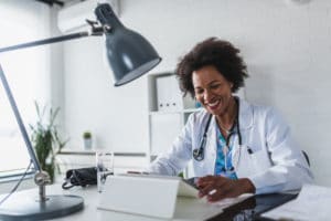 African American female doctor working on tablet